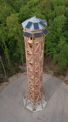 Poster - Aerial shot of a watchtower with solar cell panels in the forest