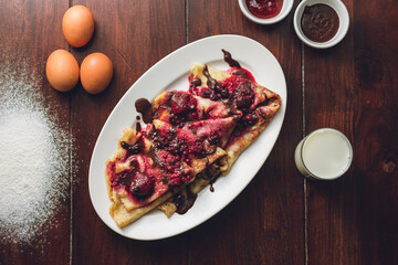 Canvas Print - Closeup of the pancakes with forest fruits and chocolate.