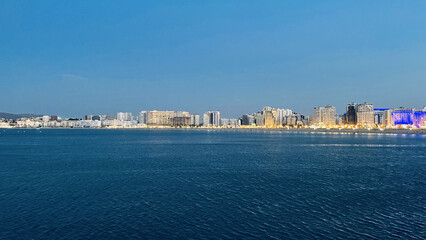 Wall Mural - Beautiful view of the blue sea with the city in the background. Tanja Marina Bay, Morocco.