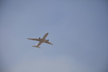 Sticker - Plane flying in the clear blue sky.