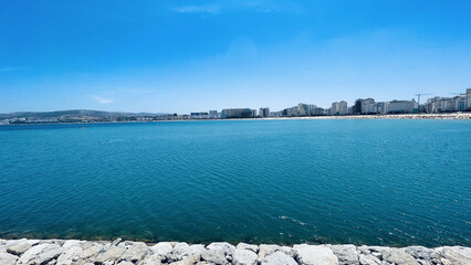 Poster - Beautiful view of the blue sea with the city in the background. Tanja Marina Bay, Morocco.