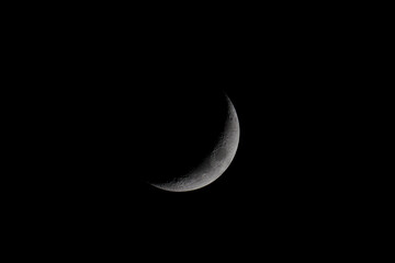 Canvas Print - Barely visible crescent moon in a black sky