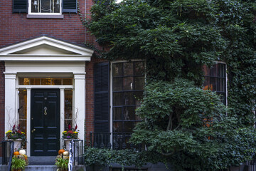 Sticker - View of a front door to an apartment building. Windows with shutters and brick wall