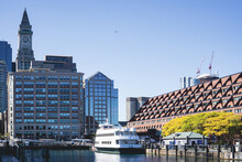 View Of Buildings And Waterfront With A Charter Boat Docked In Harbor