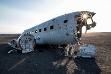 Crashed White Airplane With Its Remnants On A Lonely, Vast Field In Iceland