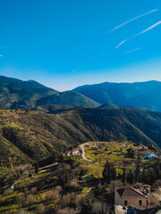 Canvas Print - High angle shot of houses constructed near the mountains in summer