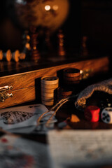 Canvas Print - Playing cards with game dices and chess pieces on a table in the sunlight