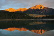 Mesmerizing scene of sun on the top mountains reflecting on the Patricia Lake water