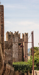 Canvas Print - Vertical shot of a Historical stone building in Gradara, Italy against a blue sky