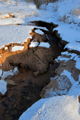 Sticker - Vertical shot of snowy rocks and land on a seashore