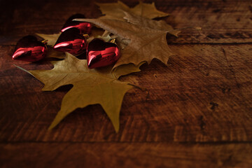 Wall Mural - Valentine's Day decorations and leaves on a wooden table