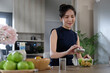 © wattana - Beautiful asian woman making healthy vegan salad in the kitchen at home.