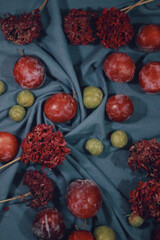 Wall Mural - Vertical shot of different fruits and flower on a blue table mat