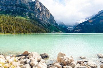 Poster - Beautiful view of the Louise Lake and the mountains with forest in Alberta, Banff, Canada