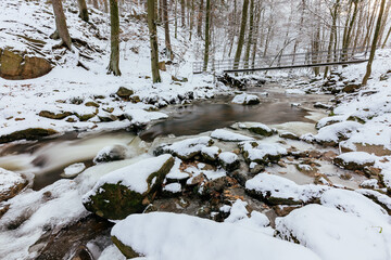 Sticker - View of Harz mountain river Ilse in Ilsenburg with ice and snow at wintertime Germany