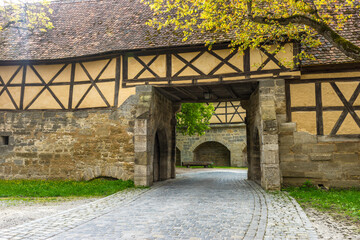 Poster - Closeup of a building with an archway in Rothenburg, Germany