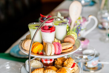 Poster - Served white table with a set of various desserts in the restaurant