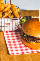 Sticker - Closeup shot of an appetizing burger with French fries on a wooden board