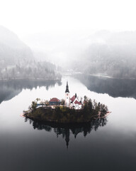 Poster - Aerial view of a building on a lake at the fog