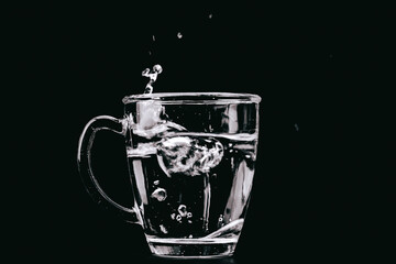 Poster - Glass of water on the black background