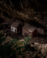 Poster - Wooden houses under giant rocks