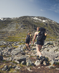 Wall Mural - People hiking in mountain Trolltunga, Norway