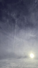 Wall Mural - sun, cloudy sky and vapor trail