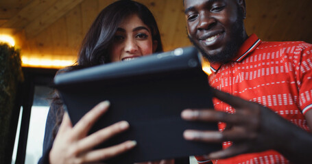 Poster - South Asian couple looking at a phone together