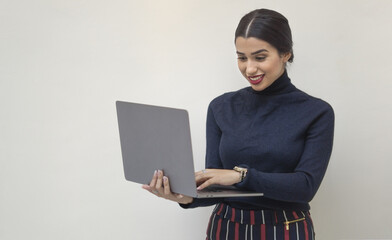 Canvas Print - Smiling attractive Cuban woman working with her laptop - work from home concept