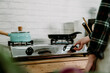 © PR Image Factory - unrecognized wife in home kitchen preparing dinner for family. female hand turning on and off gas stove burner under frying pan in cooking place. woman lighting up burning stove with fire warm pot