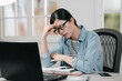 © PR Image Factory - Stressed student woman studying for exam at home feeling hurting head. asian japanese college girl frowning face massage forehead while suffer headache during doing homework in daytime in apartment