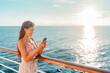 © Maridav - Cruise travel vacation Asian lady using smartphone on holidays in Caribbean. Happy young woman texting online.