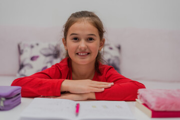 Wall Mural - A happy student girl learning in home. 