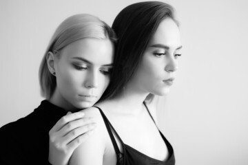 Top view of two young women on a light background.