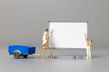 Miniature People Painter At The Front Of A Whiteboard