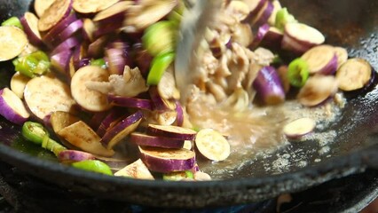 Wall Mural - Frying eggplant with minced pork in pan , in door Chiangmai Thailand