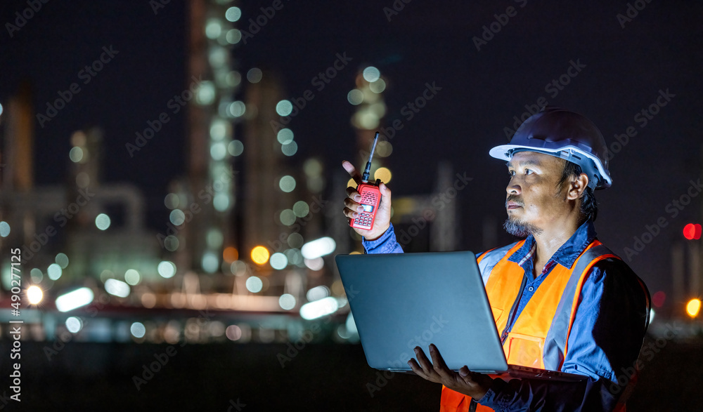 Foto de Stock Engineer wearing safety uniform and helmet looking detail ...