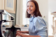 © Monkey Business - Portrait Of Smiling Teenage Girl At Home Playing The Piano