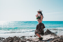 Hawaiian Woman Enjoys Hula Dancing On The Beach Barefoot Wearing Traditional Costume