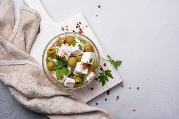 Wall Mural - Bowl of delicious olives with Feta cheese in oil