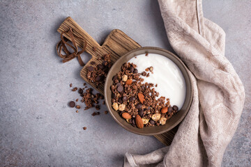 Wall Mural - Healthy breakfast of granola with nuts, chocolate drops and yogurt