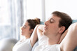 © Egoitz - Man and woman resting with closed eyes on couch