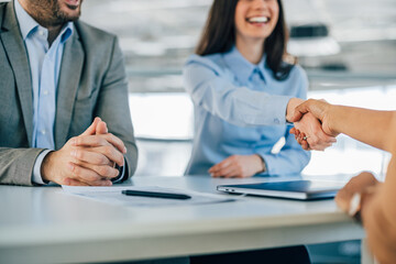 Smiling businesswoman made a deal with another company.