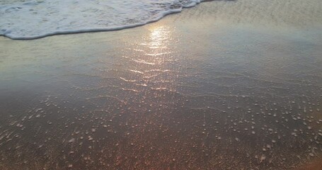 Wall Mural - Calm waves of the archipelago slowly break on the sandy beach at dawn in Summer