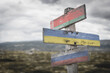 Belarus ukraine russia flag on wooden signpost outdoors in nature. Conflict in ukraine concept.