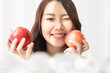 © Shutter B - Healthy lifestyle, Close up beautiful young asian woman holding apple with smiling happy. Healthy eating, Food and lifestyle, Health, Beauty, Dieting concept.