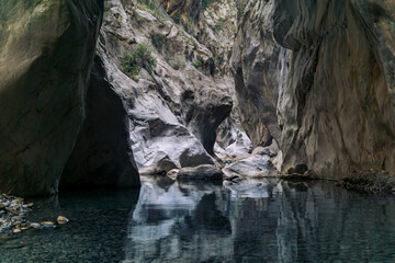 Wall Mural - clear transparent lake at the bottom of a deep canyon