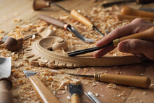 Craftsman Carving With A Gouge. Woodwork. Workbench With Equipment. Wood Carving Tools. Chisels For Carving