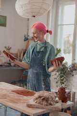 Female ceramist working with raw clay in pottery studio