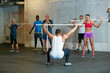 © Daniel L/peopleimages.com - Leading his class. Shot of a fitness group working out at the gym.